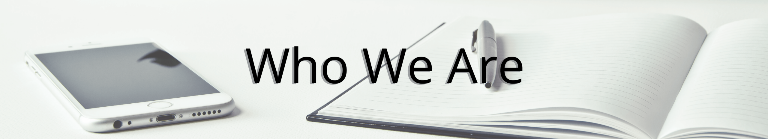 Who is The Staffing Center? Header - Image of an iPhone with a notebook laid on a table with the words Who We Are overlaid on top.